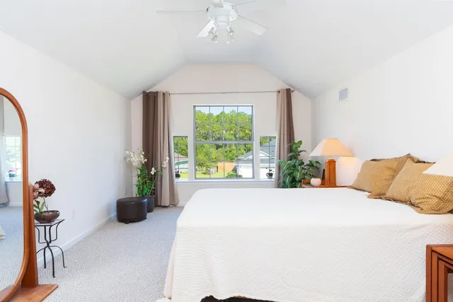 a bed sitting in a bedroom next to a window