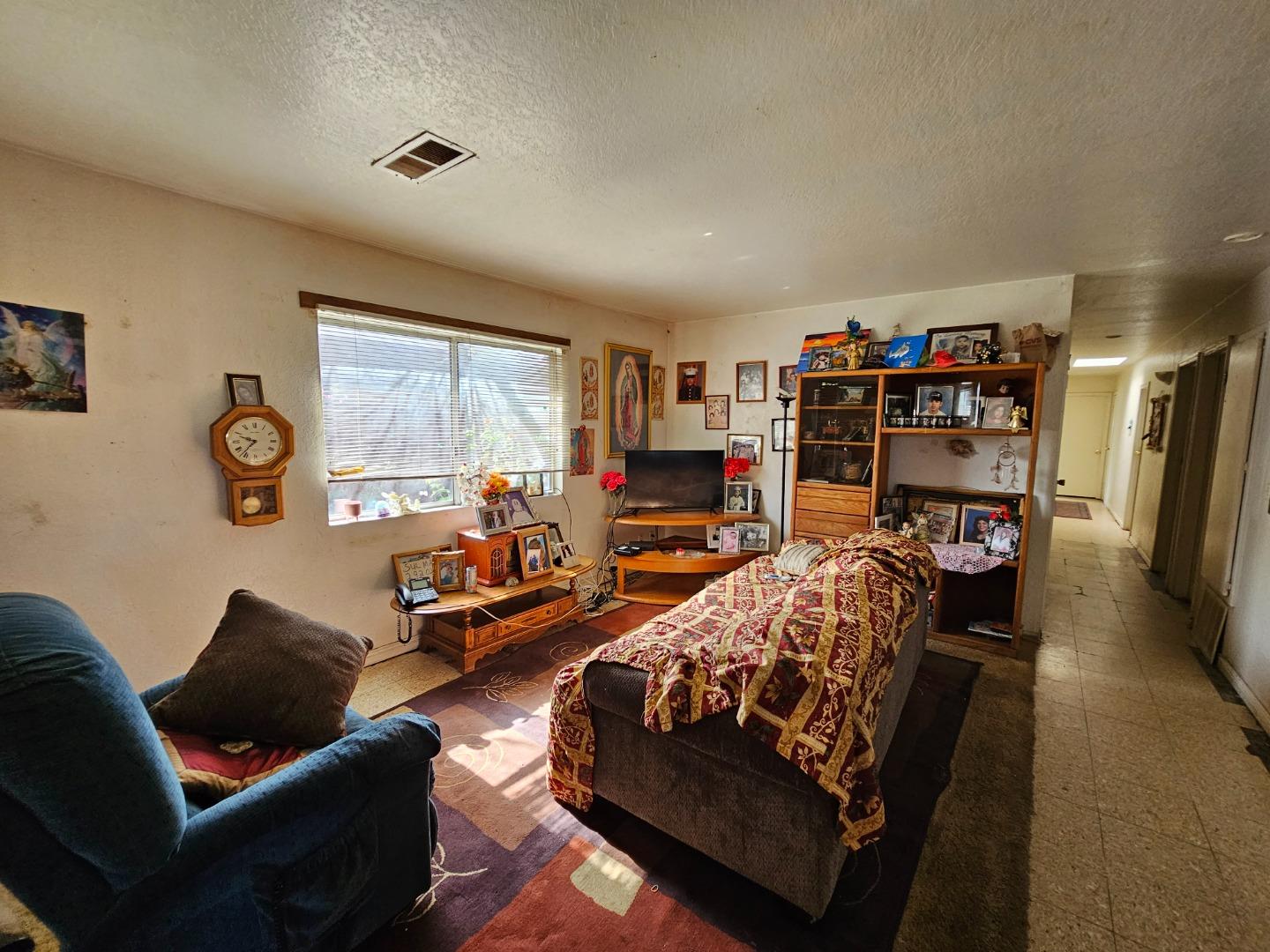 206 Montezuma Drive Soledad, CA 93960 - Photo 2 of 8 a bedroom with furniture and a book shelf