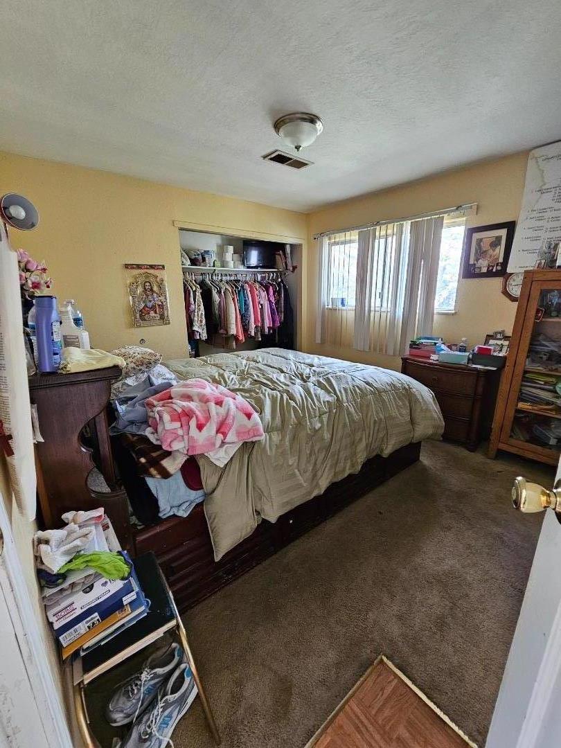 206 Montezuma Drive Soledad, CA 93960 - Photo 6 of 8 a bedroom with a bed and wooden floor