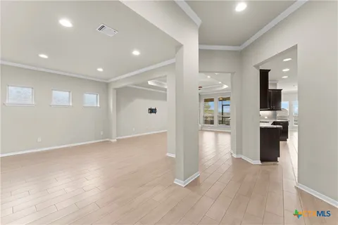 a view of kitchen with refrigerator and wooden floor