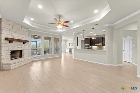a view of a big room with chandelier and a fireplace