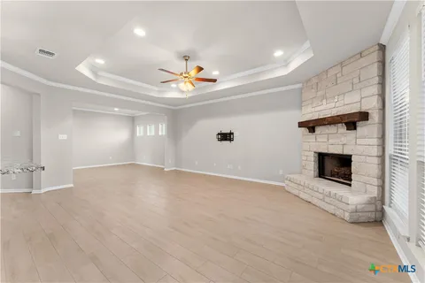 a view of an empty room with a fireplace