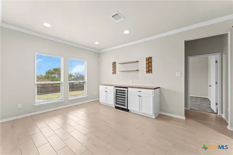 a view of a kitchen with furniture and natural light
