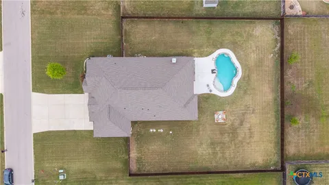 a swimming pool with outdoor seating and yard