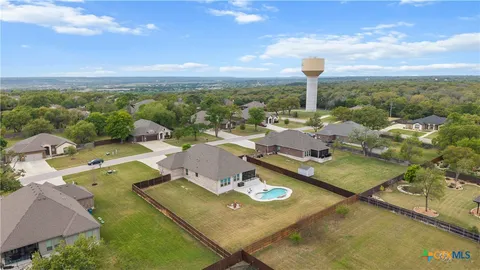 an aerial view of residential houses with outdoor space and swimming pool