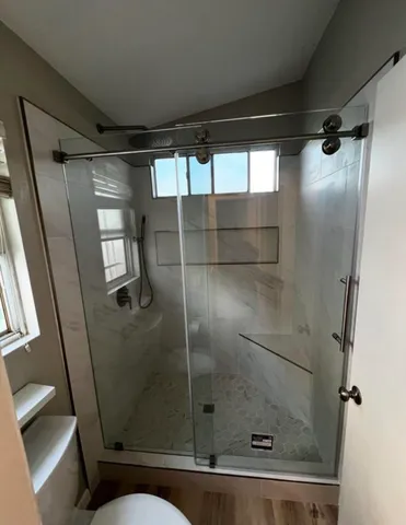 a bathroom with a shower and toilet