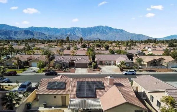 an aerial view of residential houses with outdoor space