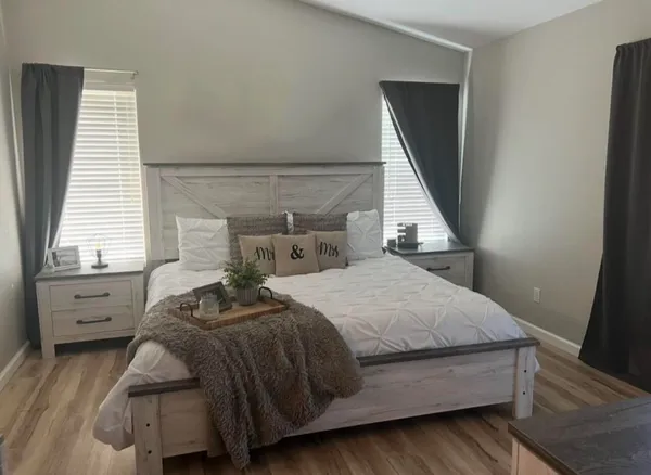 a bedroom with a bed and a window