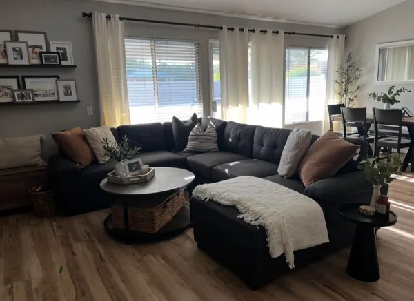 a living room with furniture and wooden floor