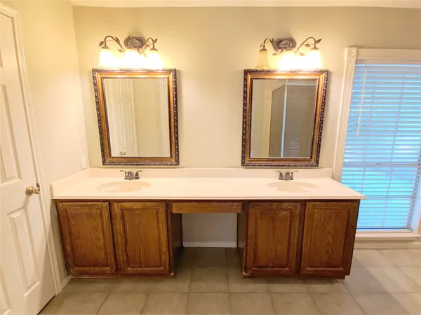 a bathroom with a double vanity sink and a mirror