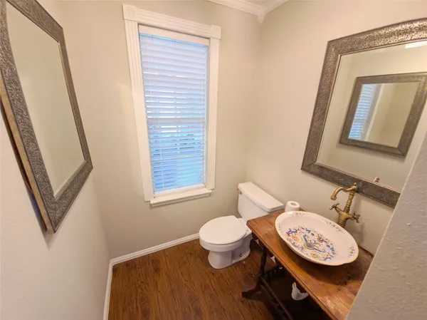 a bathroom with a toilet a sink and a mirror