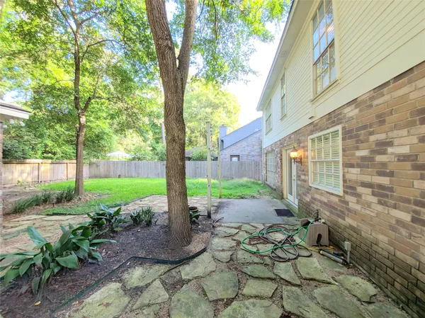 a view of a patio with table and chairs next to a yard