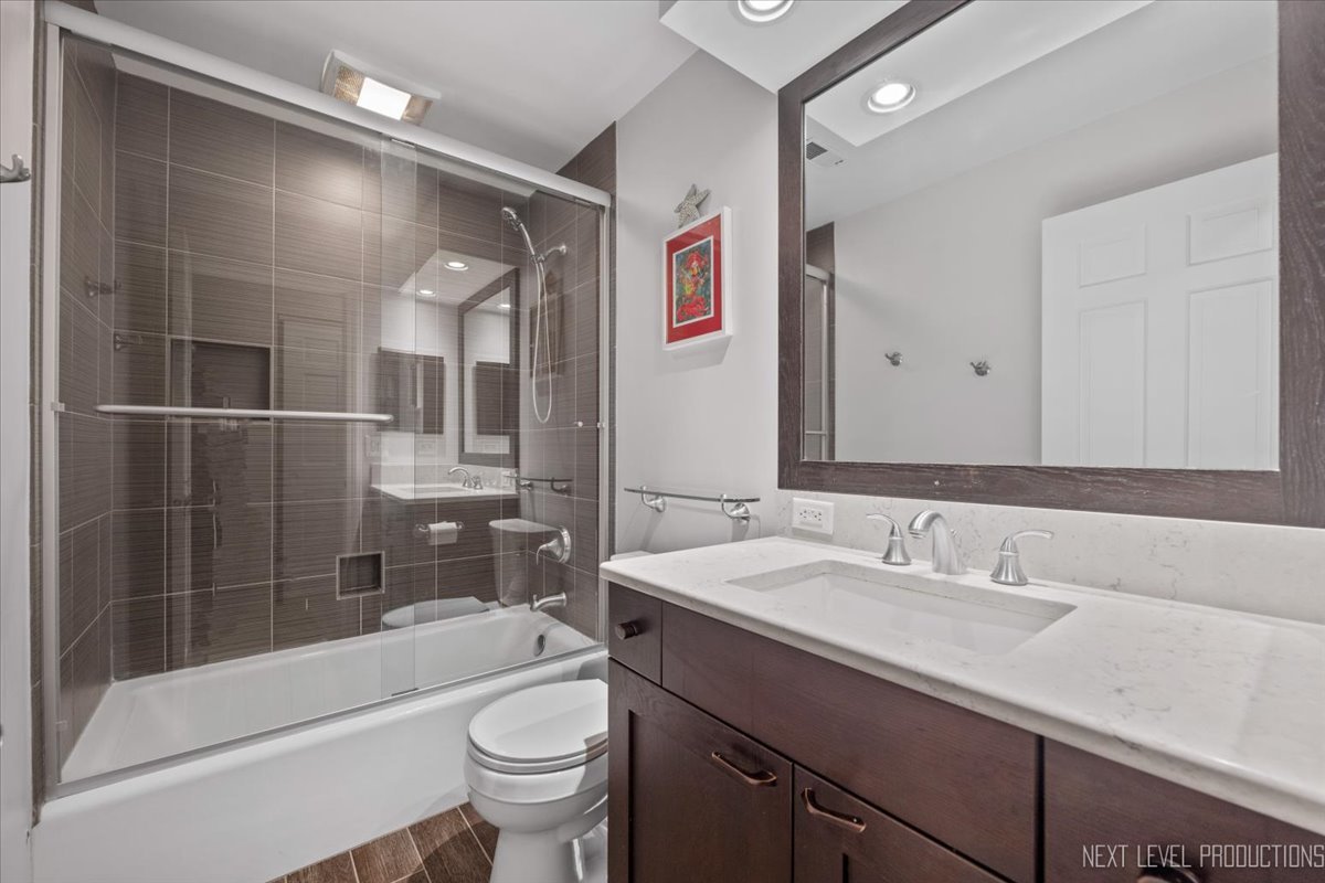 1009 East Bailey Road Naperville, IL 60565 - Photo 19 of 33 a bathroom with a sink a toilet and shower