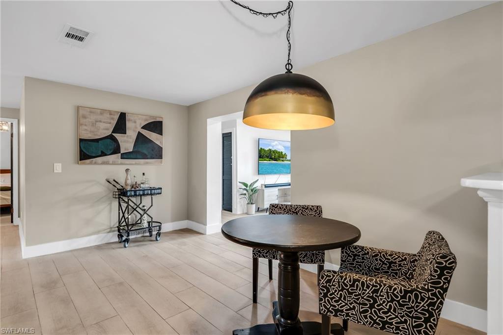 1840 23rd Street Southwest Naples, FL 34117 - Photo 14 of 50 Breakfast area featuring pendant light and light wood plank porcelain tile flooring