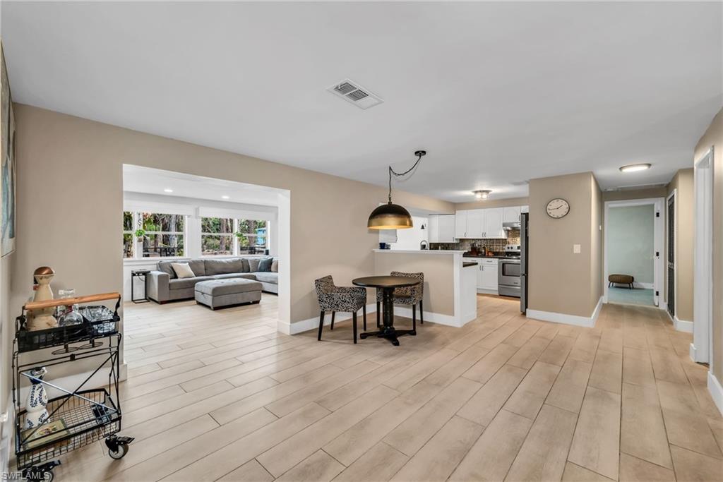 1840 23rd Street Southwest Naples, FL 34117 - Photo 15 of 50 Living area featuring wood plank porcelain tile flooring