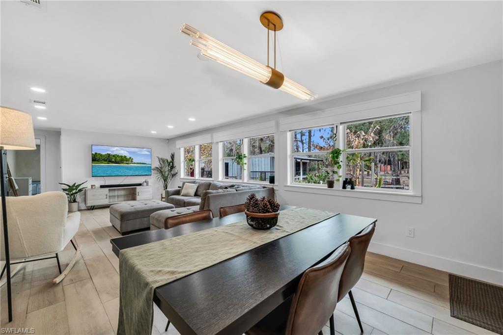 1840 23rd Street Southwest Naples, FL 34117 - Photo 23 of 50 Dining area featuring pendant light, recessed lighting and wood plank porcelain tile flooring