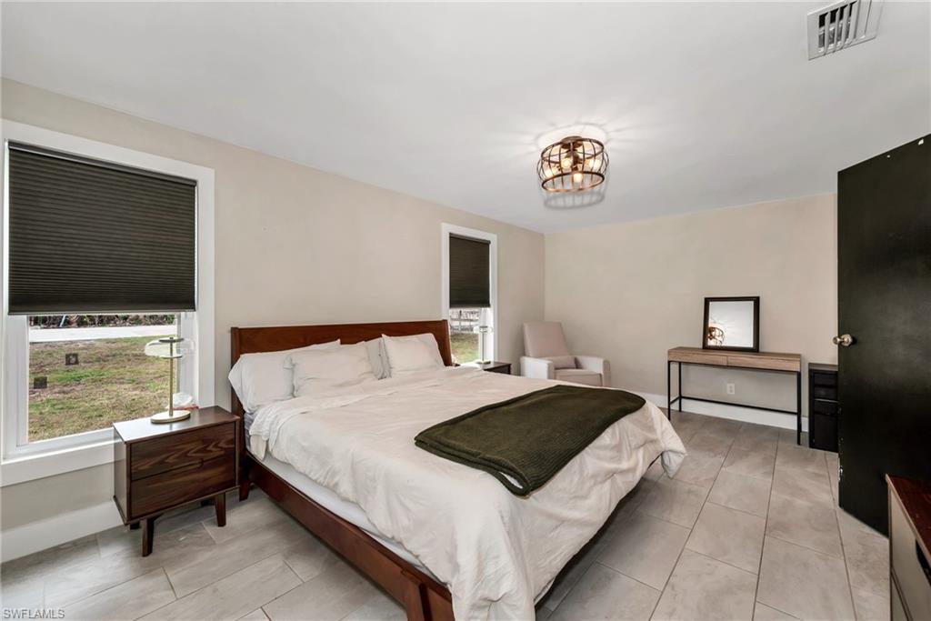 1840 23rd Street Southwest Naples, FL 34117 - Photo 24 of 50 Bedroom featuring limewash paint and tile flooring