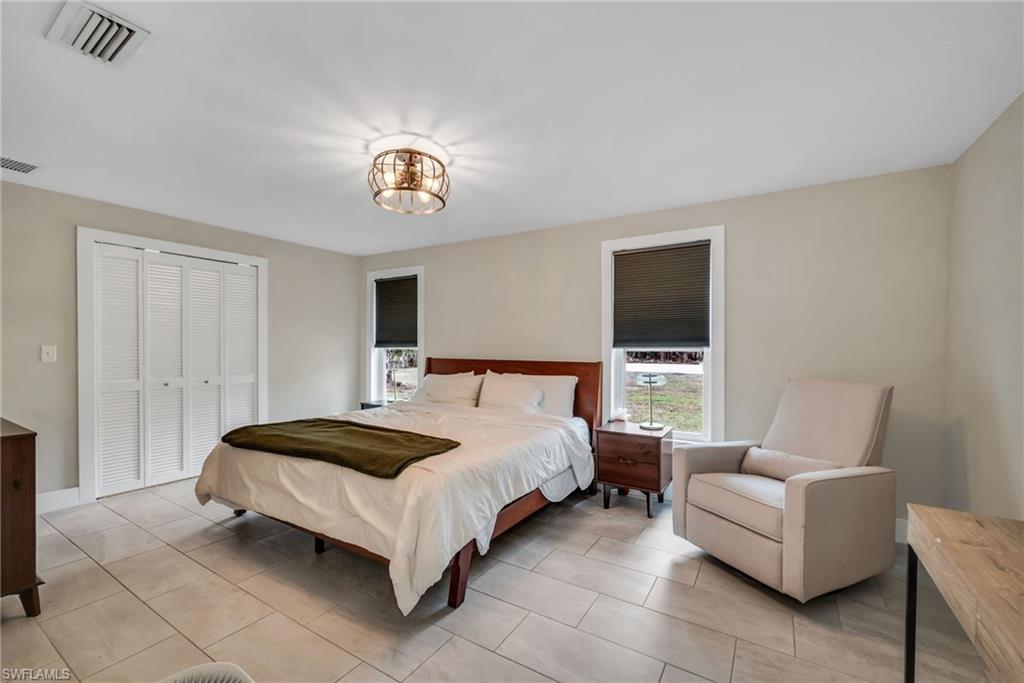 1840 23rd Street Southwest Naples, FL 34117 - Photo 25 of 50 Bedroom featuring limewash paint and tile flooring