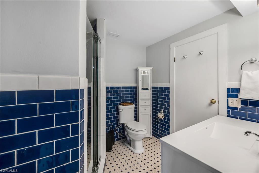 1840 23rd Street Southwest Naples, FL 34117 - Photo 27 of 50 Bathroom featuring a stall shower, vanity, and tile walls