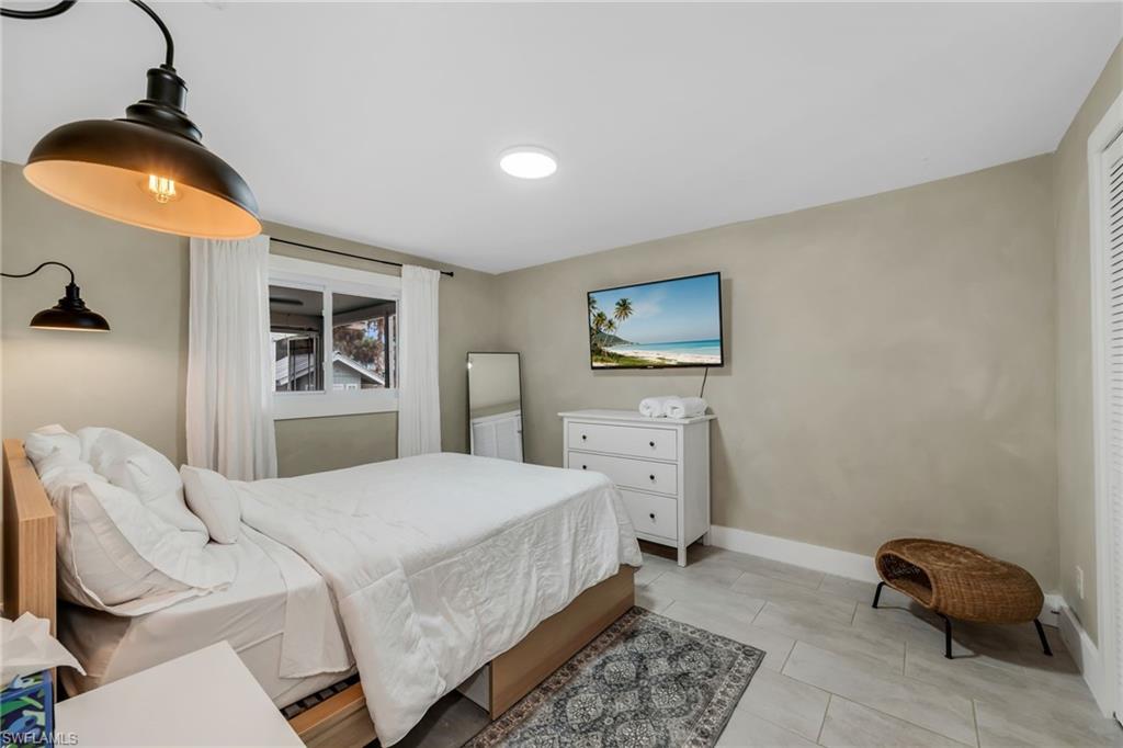 1840 23rd Street Southwest Naples, FL 34117 - Photo 28 of 50 1 Guest bedroom featuring limewash paint and tile flooring