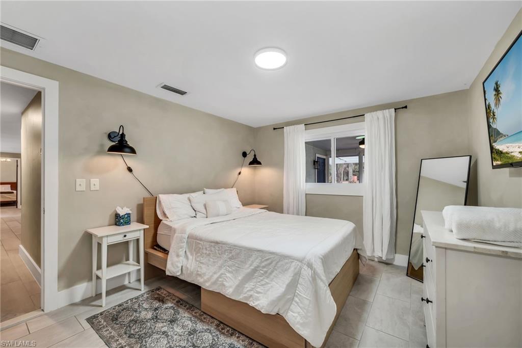 1840 23rd Street Southwest Naples, FL 34117 - Photo 29 of 50 1 Guest bedroom featuring limewash paint and tile flooring