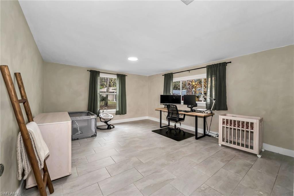 1840 23rd Street Southwest Naples, FL 34117 - Photo 31 of 50 2 Guest bedroom featuring limewash paint and tile flooring