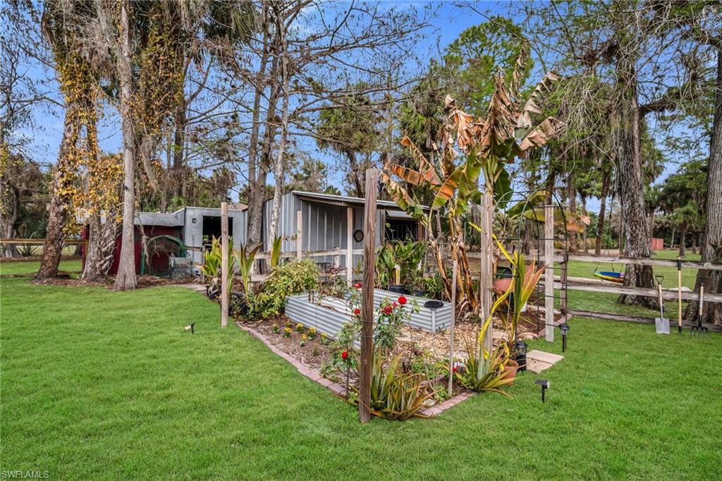 1840 23rd Street Southwest Naples, FL 34117 - Photo 50 of 50 View of lawn featuring a vegetable garden