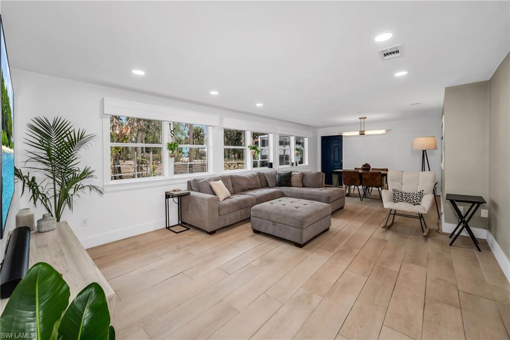 1840 23rd Street Southwest Naples, FL 34117 - Photo 6 of 50 Living area featuring light wood plank porcelain tile flooring and recessed lighting