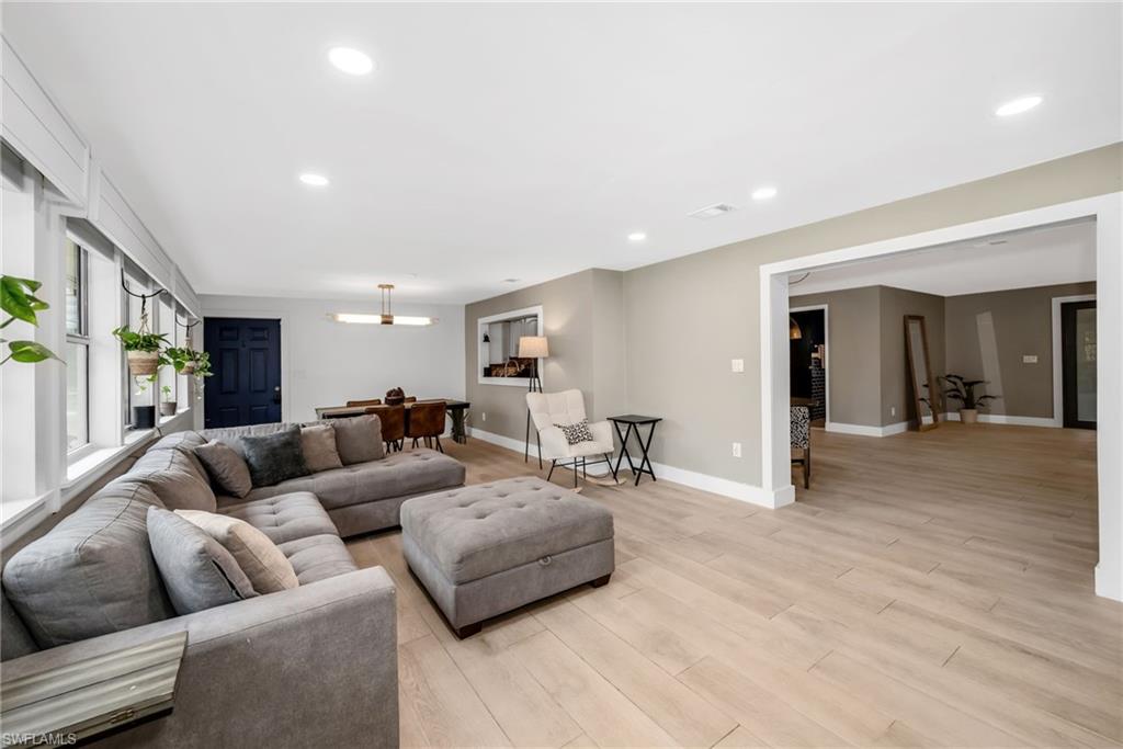 1840 23rd Street Southwest Naples, FL 34117 - Photo 7 of 50 Living area featuring light wood plank porcelain tile flooring and recessed lighting