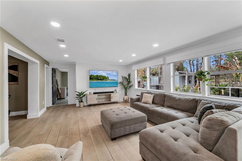 1840 23rd Street Southwest Naples, FL 34117 - Photo 8 of 50 Living area featuring light wood plank porcelain tile flooring and recessed lighting