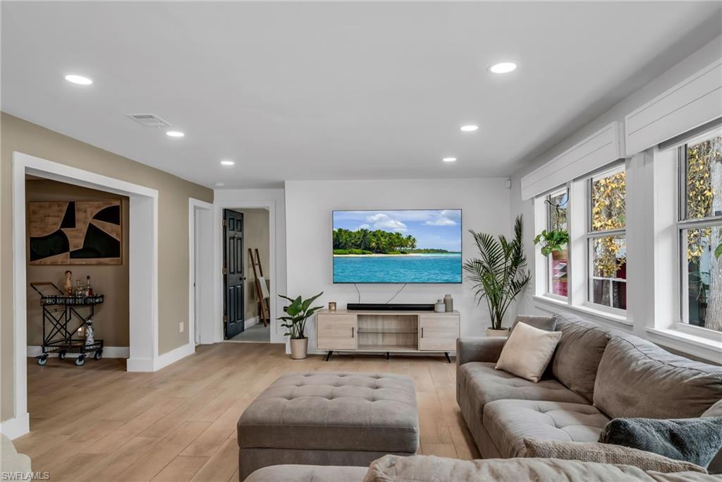 1840 23rd Street Southwest Naples, FL 34117 - Photo 9 of 50 Living area featuring light wood plank porcelain tile flooring and recessed lighting
