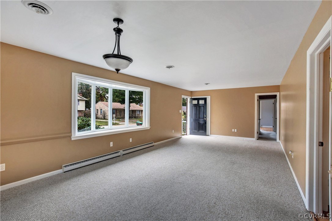 Spacious living room with wood floors under the ca