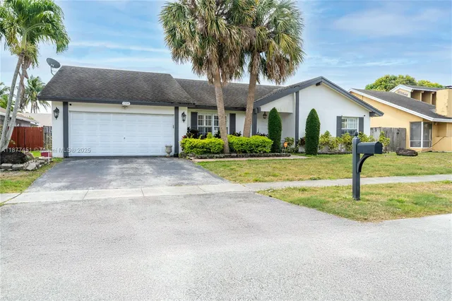 a front view of house with yard and green space