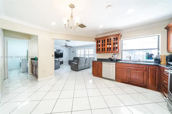 a kitchen with stainless steel appliances a refrigerator sink and cabinets