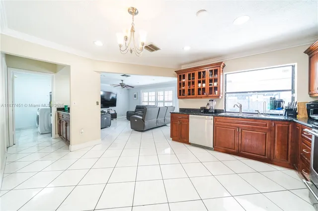a kitchen with stainless steel appliances a refrigerator sink and cabinets