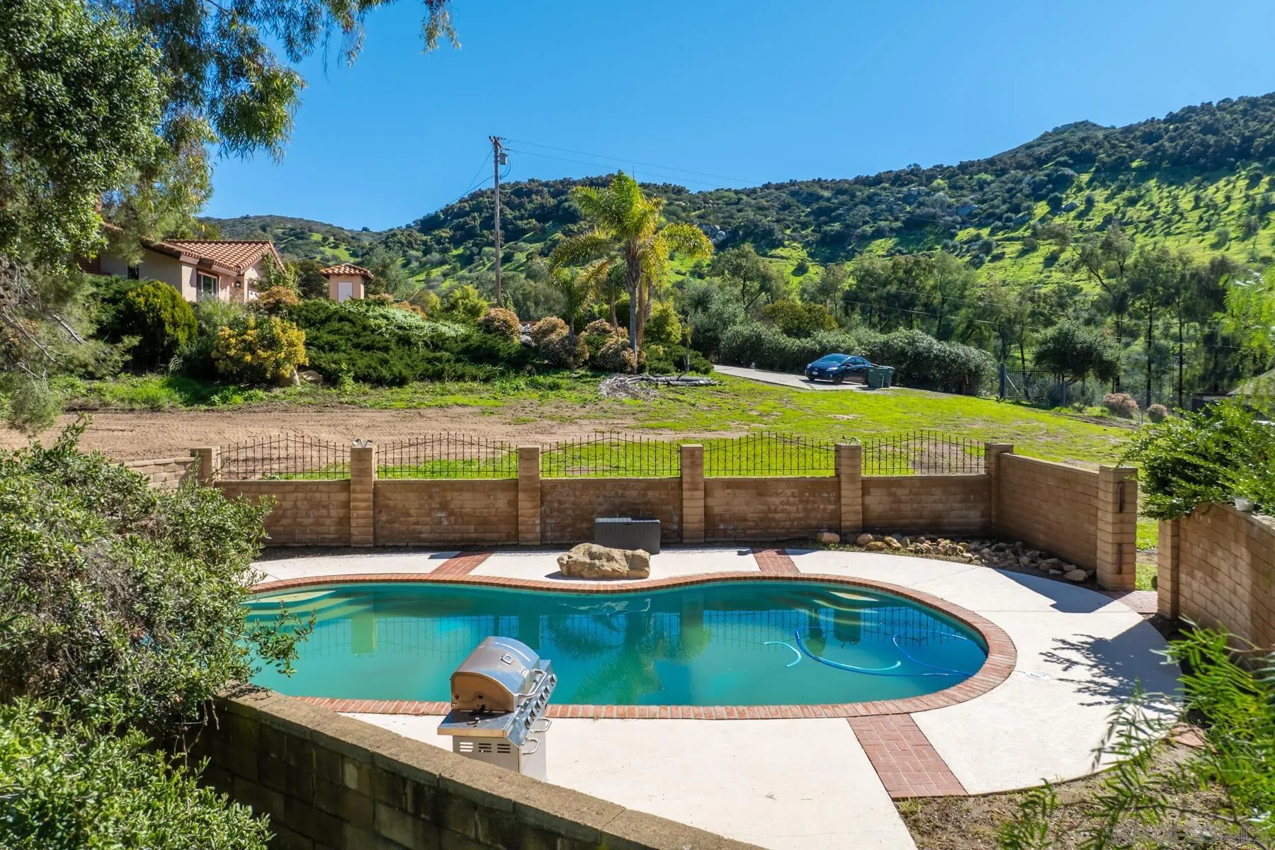 14578 Rios Canyon Road El Cajon, CA 92021 - Photo 3 of 61 a view of a swimming pool with a yard and plants