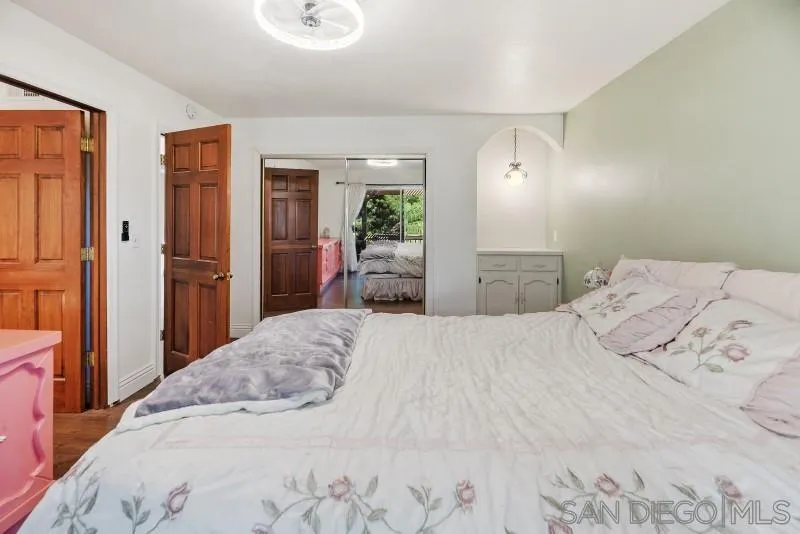 14578 Rios Canyon Road El Cajon, CA 92021 - Photo 33 of 61 a bedroom with a bed and wooden floor