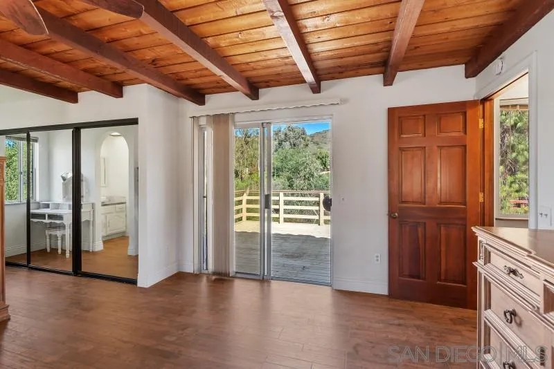 14578 Rios Canyon Road El Cajon, CA 92021 - Photo 40 of 61 an empty room with wooden floor and windows