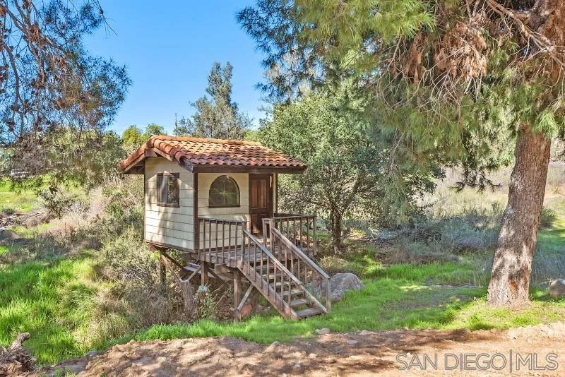 14578 Rios Canyon Road El Cajon, CA 92021 - Photo 54 of 61 a front view of a house with a garden