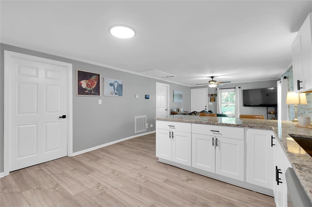 115 May Street Easley, SC 29640 - Photo 25 of 25 An open floorplan seamlessly connects the kitchen area to the adjoining living space.