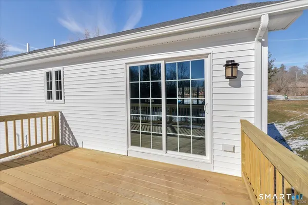 a view of a porch with a table and chairs