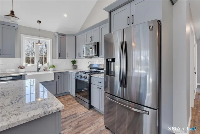 a kitchen with a refrigerator sink and stainless steel appliances