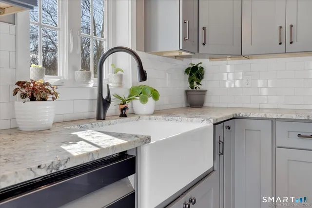 a kitchen with stainless steel appliances granite countertop a sink a stove and a granite counter tops