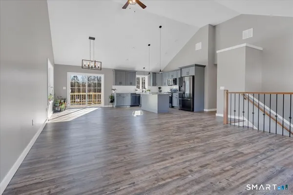 a view of a kitchen with a dishwasher and wooden floor