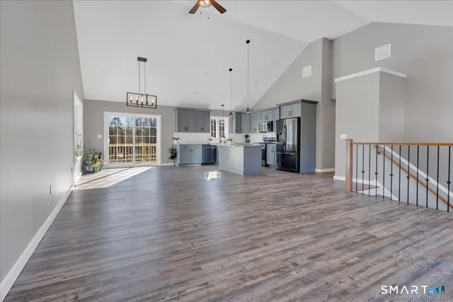 a view of a kitchen with a dishwasher and wooden floor