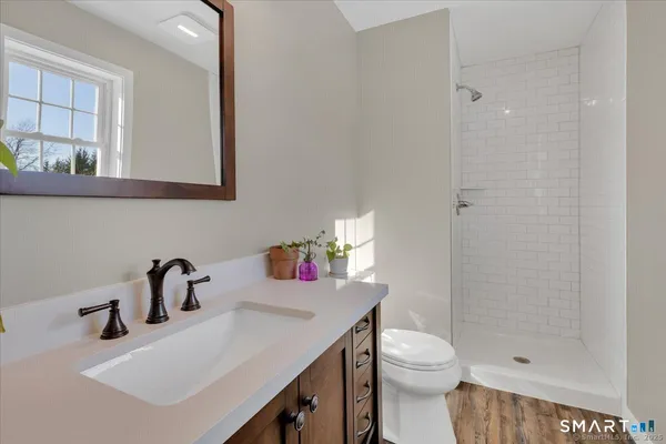 a bathroom with a sink toilet and shower