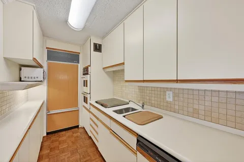 a kitchen that has a sink and a stove