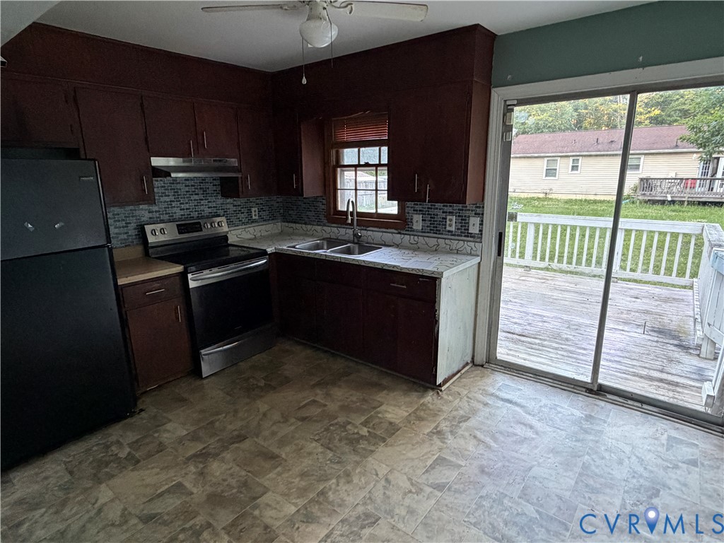 1607 Old Iron Road Hopewell, VA 23860 - Photo 3 of 12 a kitchen with stainless steel appliances granite countertop a stove a sink and a refrigerator