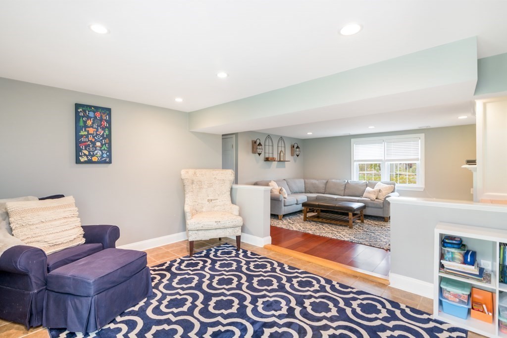 7 Geraldine Lane Braintree, MA 02184 - Photo 18 of 26 a living room with furniture and a rug