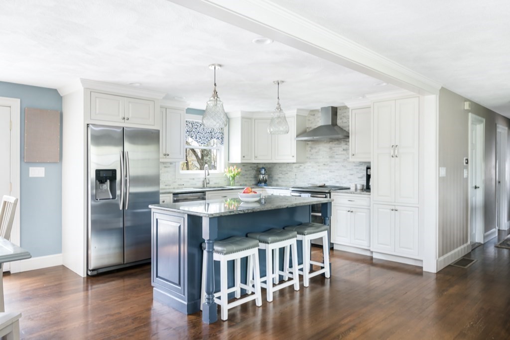 7 Geraldine Lane Braintree, MA 02184 - Photo 2 of 26 a kitchen with a center island wooden floor and stainless steel appliances
